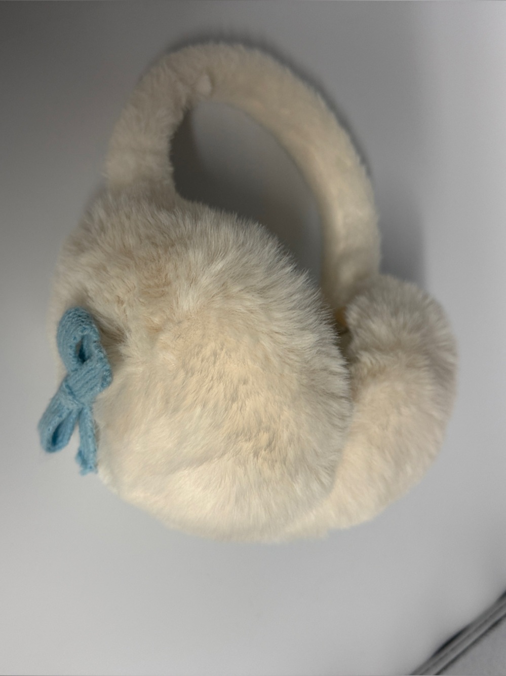 Faux Fur Cream Earmuffs with Light Blue Bow